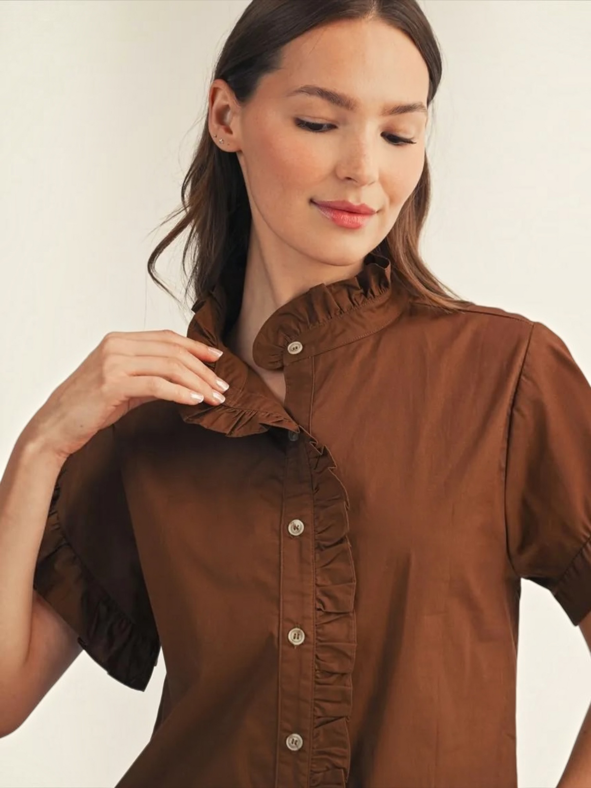 Close-up of Jodifl brown button-down top with ruffle collar and ruffle front detail